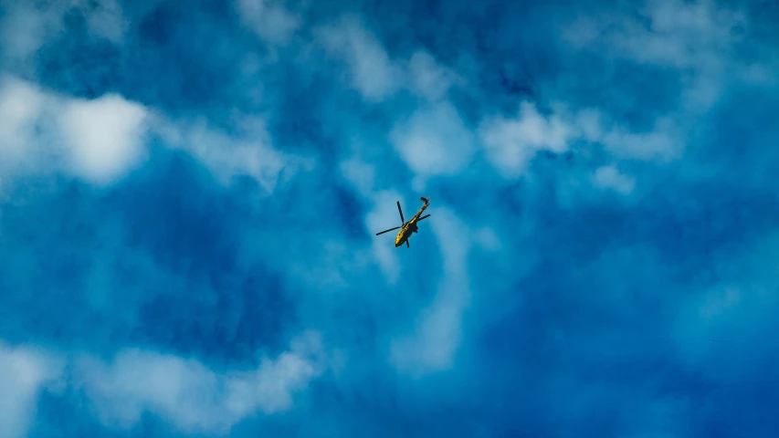 a plane flying in the air against a blue sky