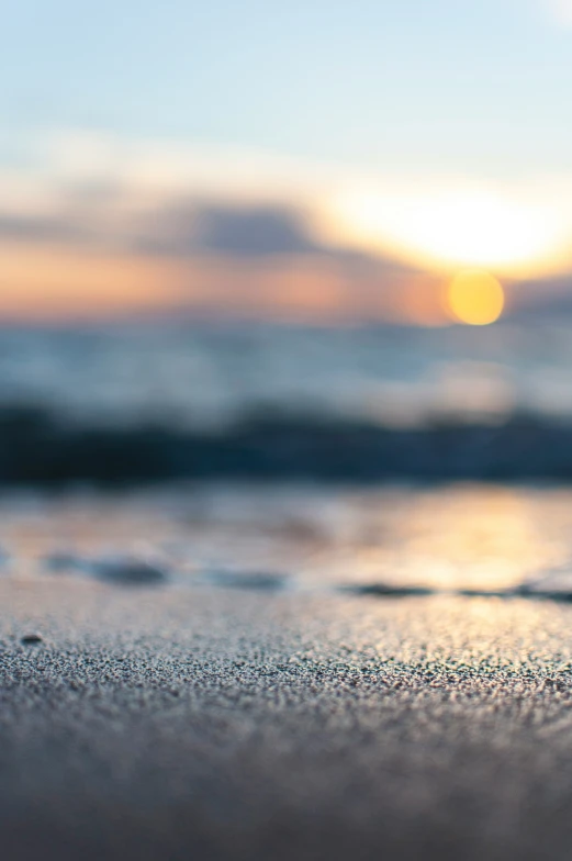 a close - up image of water droplets on sand