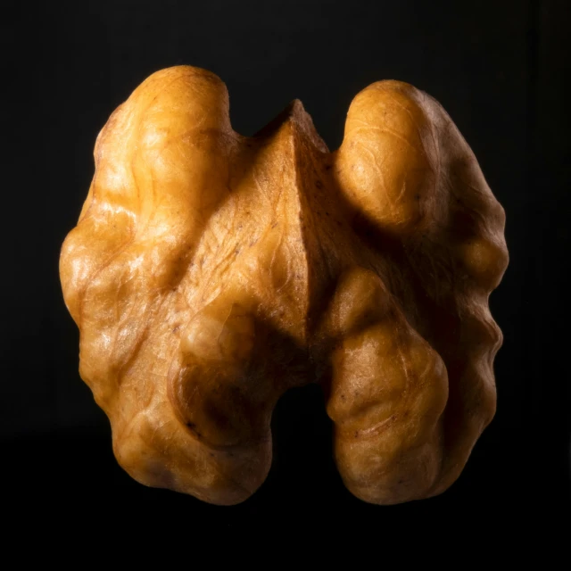 two large pieces of bread sit on a black surface