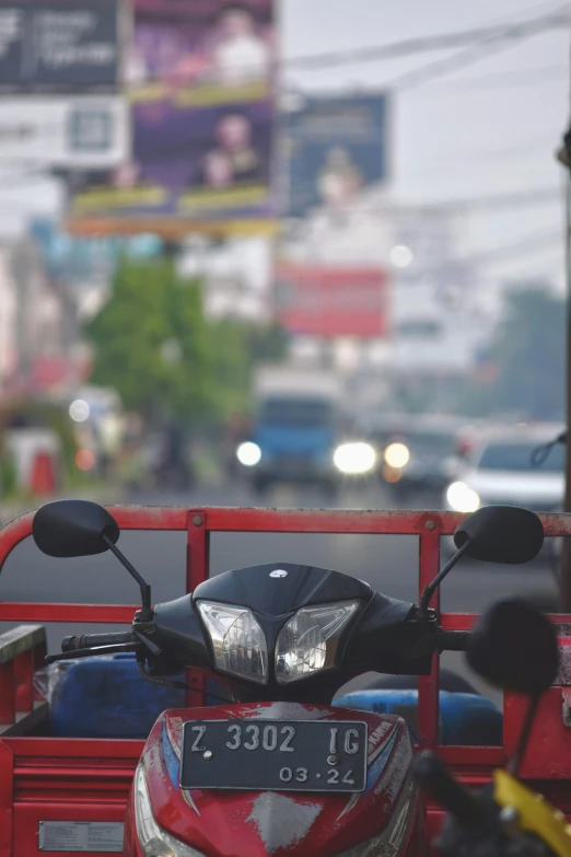 red motorcycle with back end mirror parked on city street