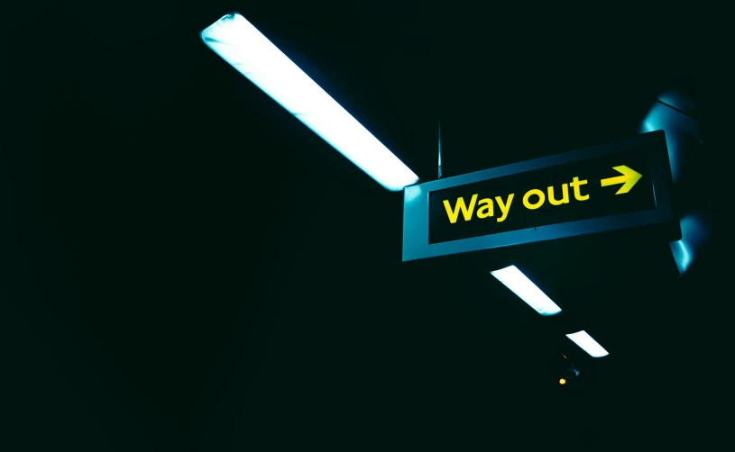 a way out sign is seen in the dark