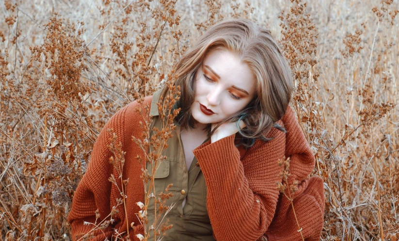 an image of a woman that is sitting in the grass