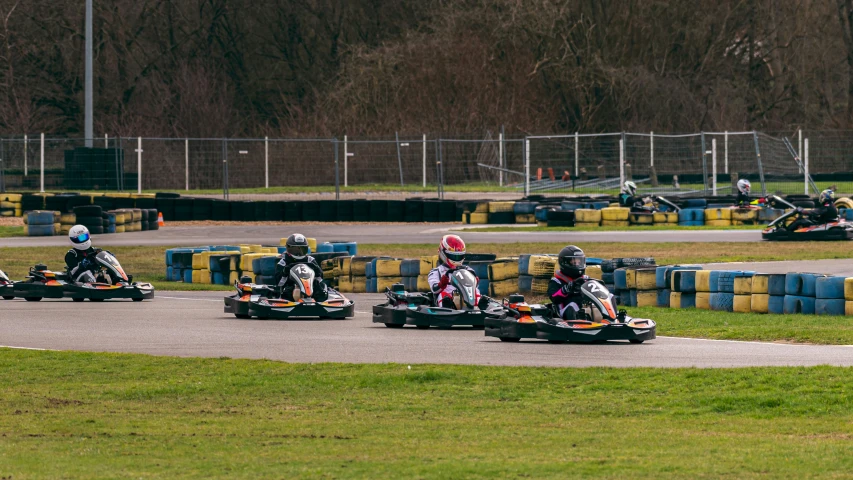 group of people riding mini carts on a track