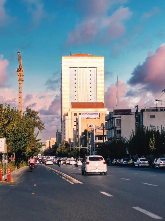 traffic on a street with tall buildings behind it