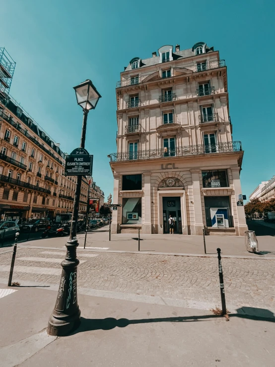 two lamp post in front of a tall building