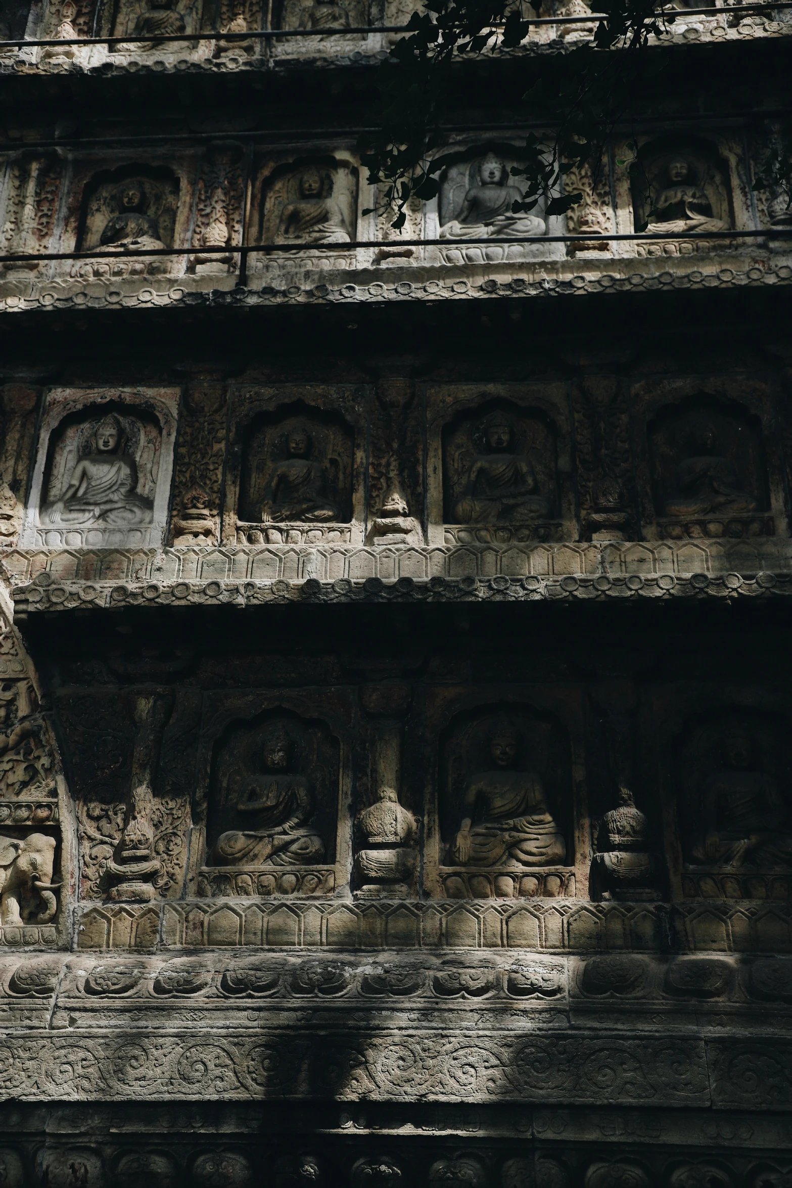 an ornate wall with statues carved on it