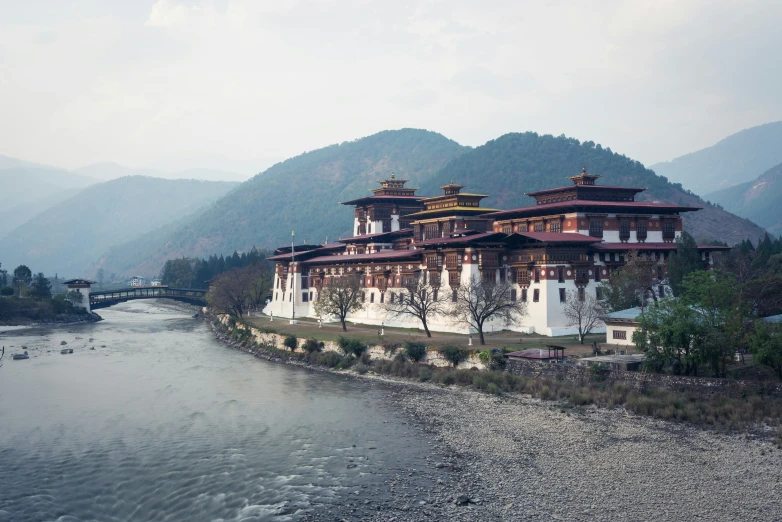 a beautiful old style building near a mountain stream