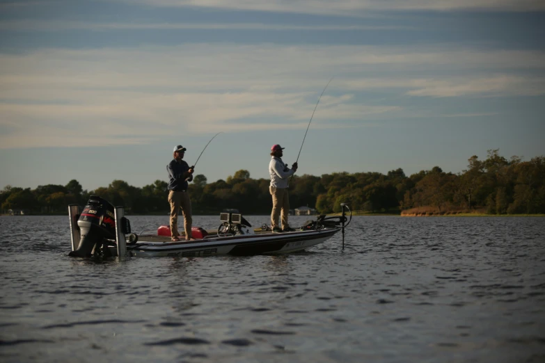 two men are fishing in their boats on the water