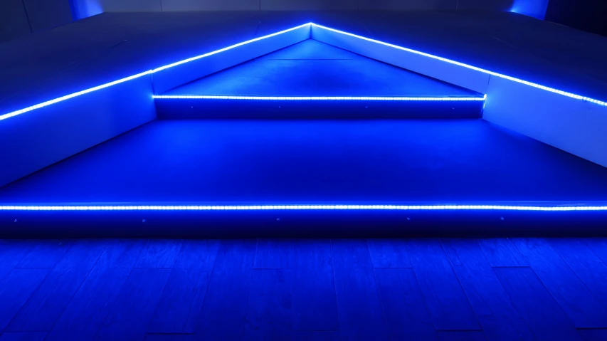 blue led lights illuminate a small room with the walls exposed