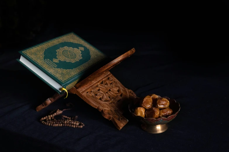 a bible on a wooden stand and nuts
