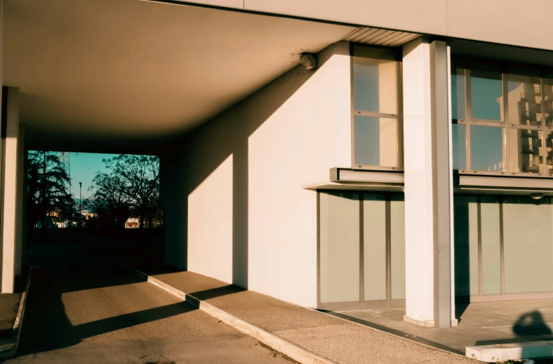 a building that is empty with windows, has concrete steps leading into it