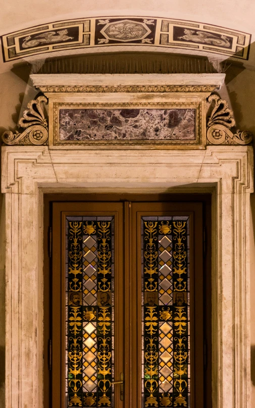 ornate glass doors with a decorative design are seen in this pograph