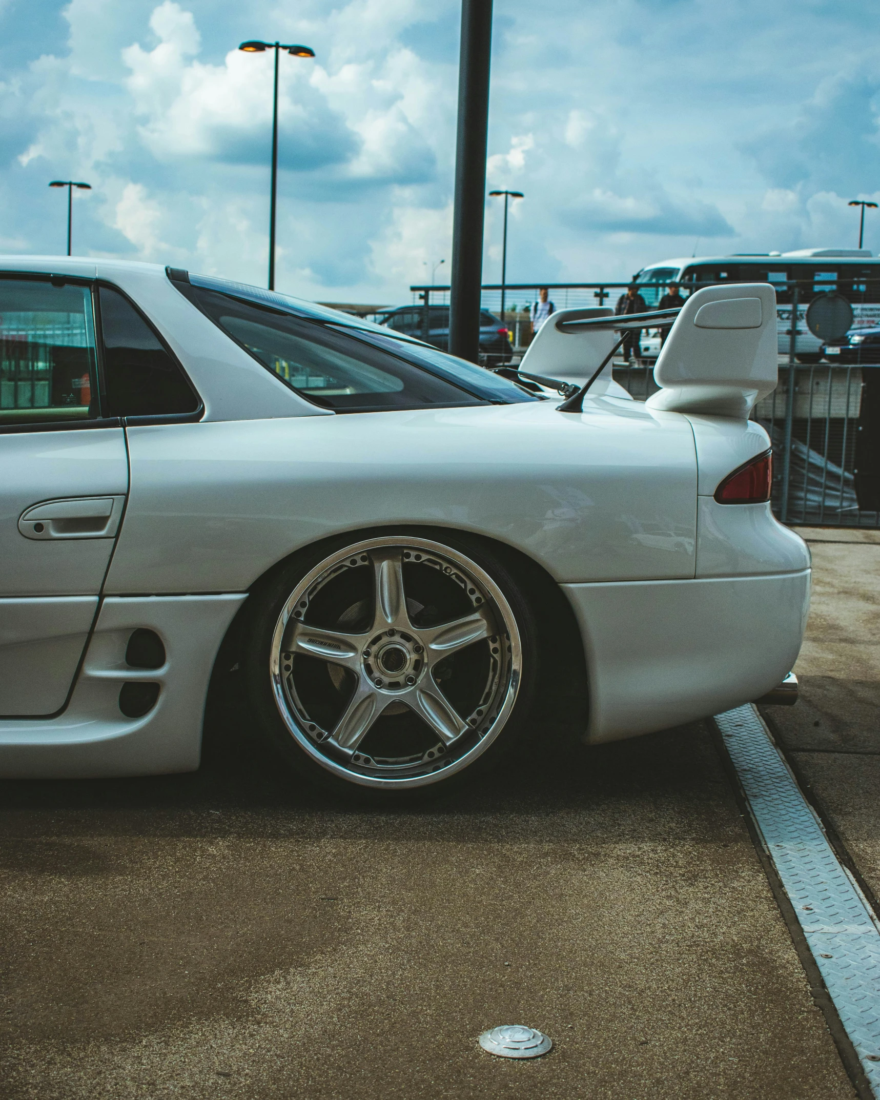 a silver sports car parked in a parking lot