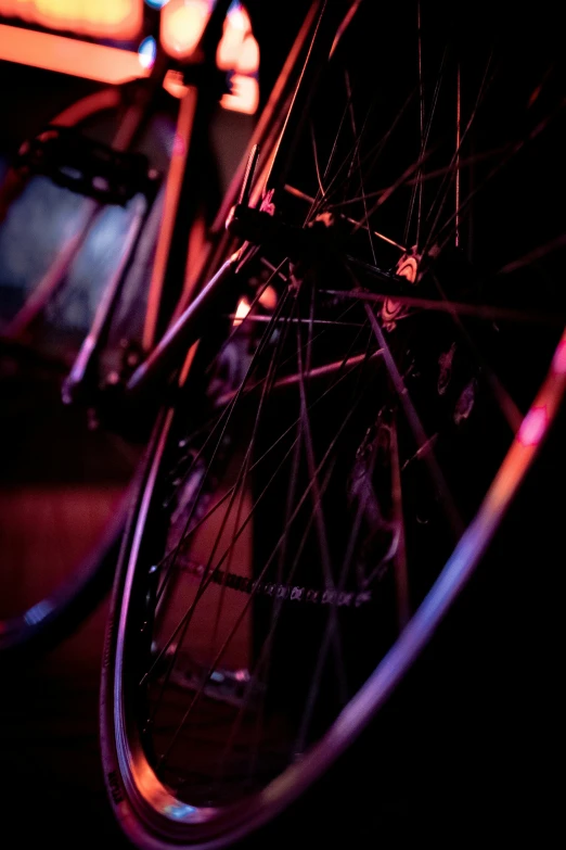 the spokes of a bicycle in neon lights