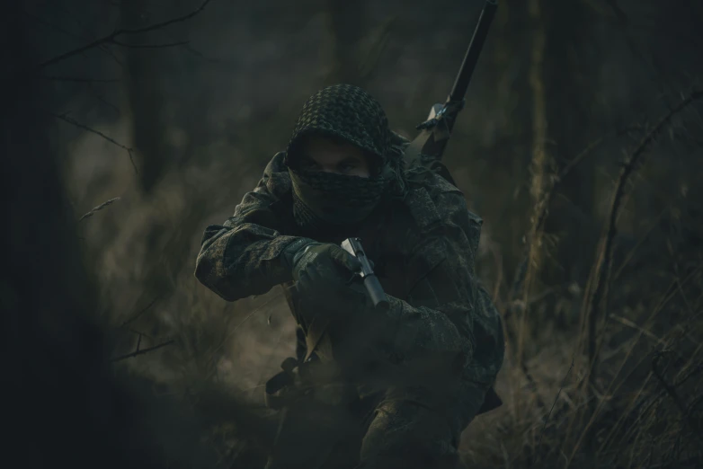 a man in a camouflaged outfit is holding a knife