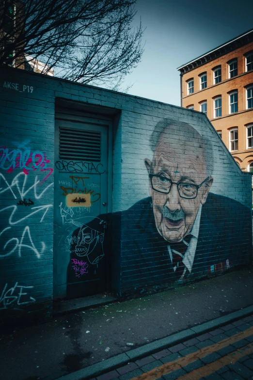 there is a painting of a man with glasses on the wall