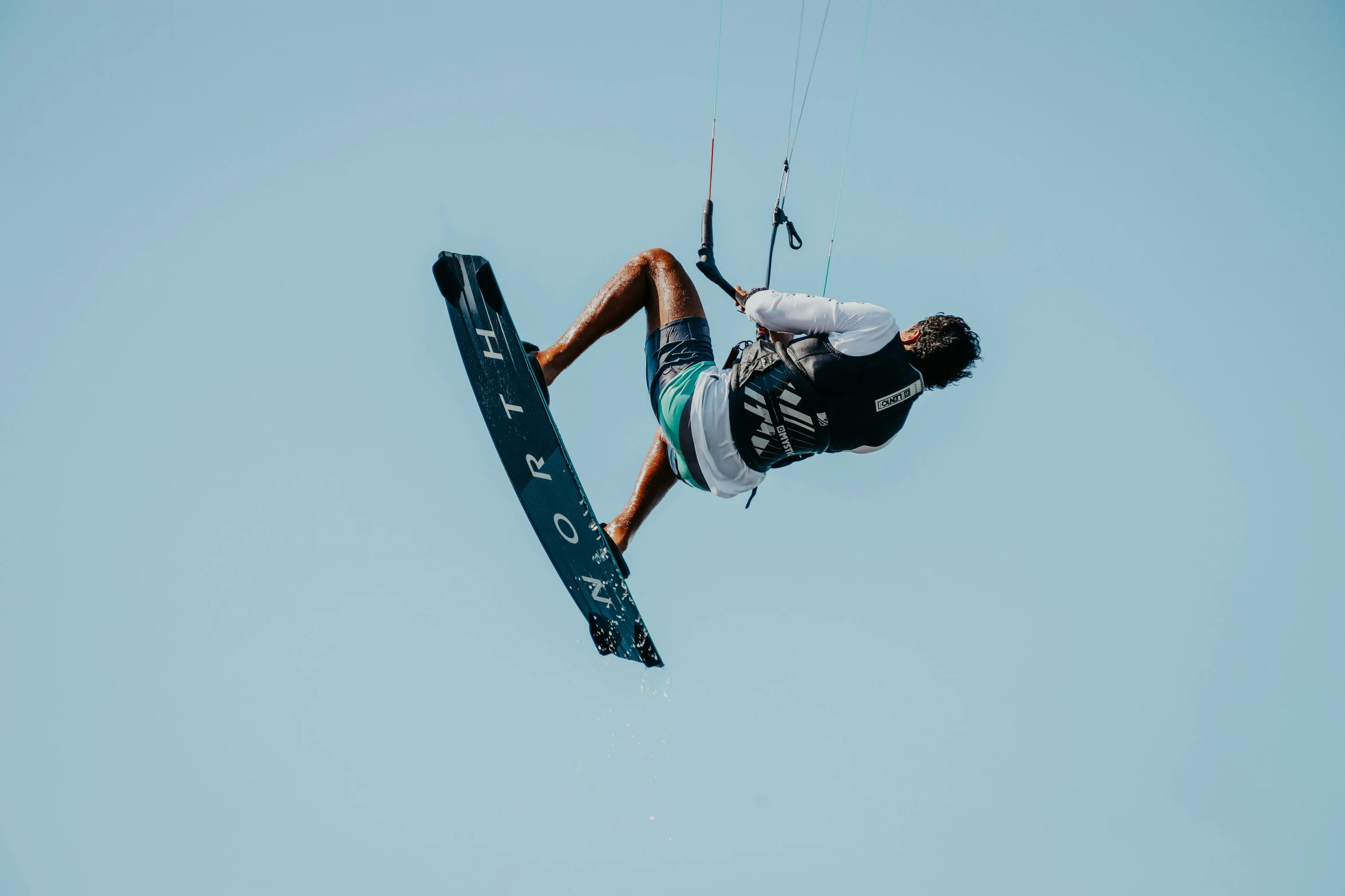 a person in mid air while para sailing in the ocean