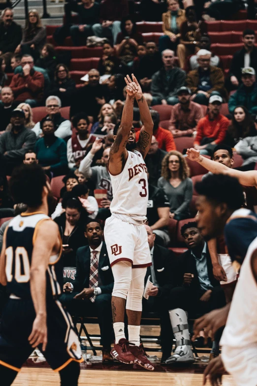 a basketball player is in mid - air trying to dunk the ball