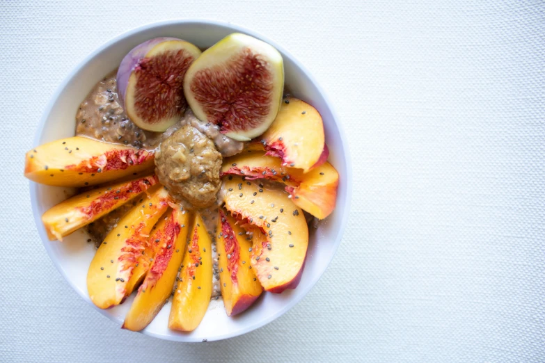 bowl of fruit topped with oatmeal and various sliced fruits