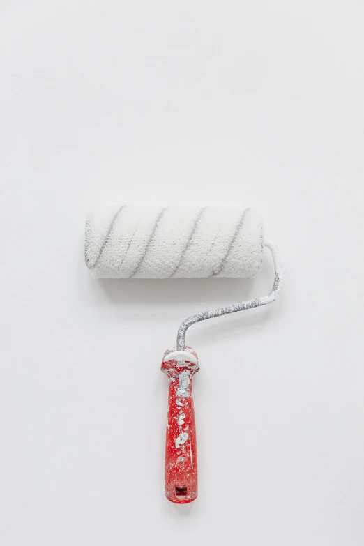 a cigarette and rolled up paper on a white surface