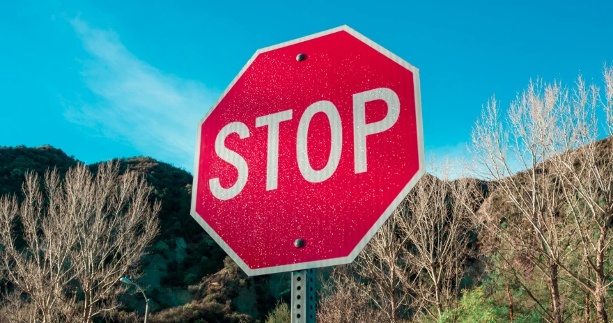 a red stop sign on the side of the road