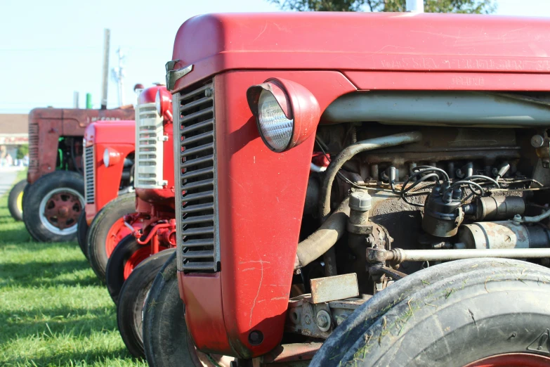 the front end of an old red tractor