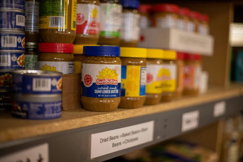 jars of nut er are on the shelf of a store