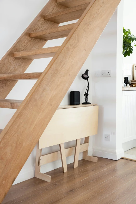 a white and wood stairs in an open floor plan