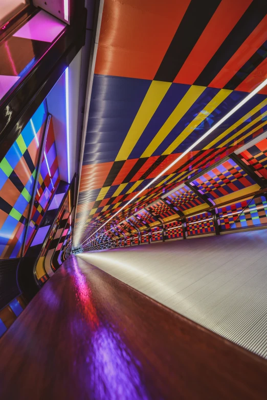 a brightly lit walkway with abstract patterns