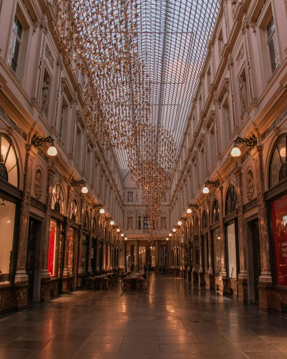 a large indoor mall that is a shopping mall with ceiling lights