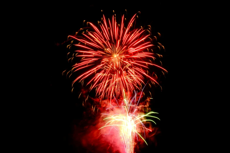 a firework display on a dark sky with colorful fireworks