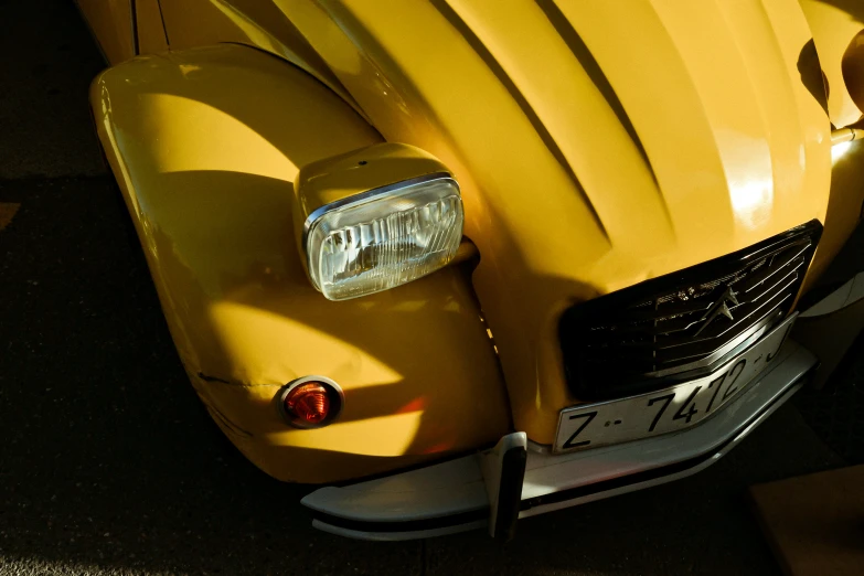 the hood of a yellow car is shown