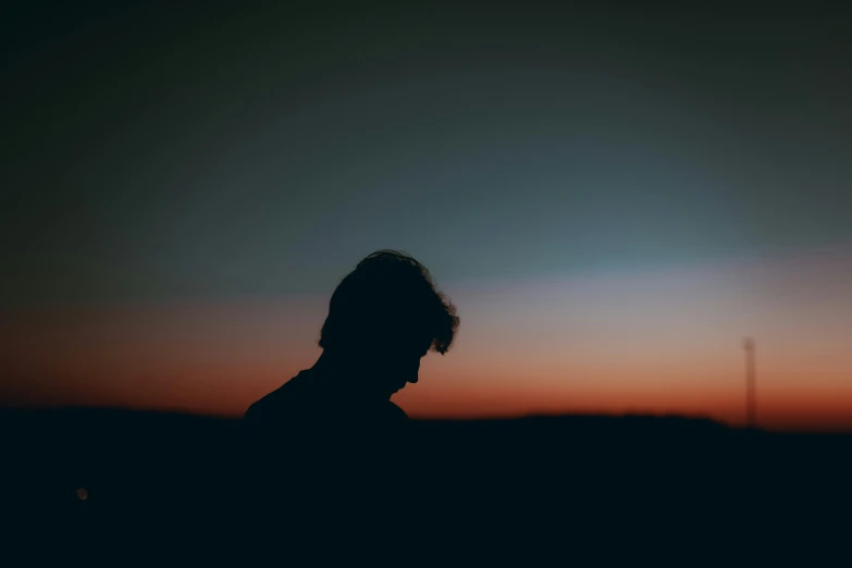 the silhouette of a person is shown in the sunset