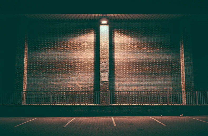 an empty parking lot at night, with the lights on