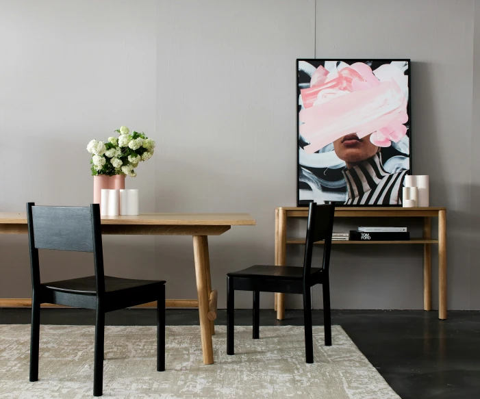 a wooden table in front of a white wall