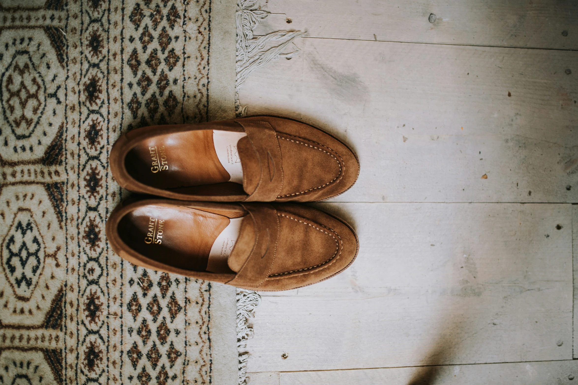 two slippers sit on top of a patterned floor