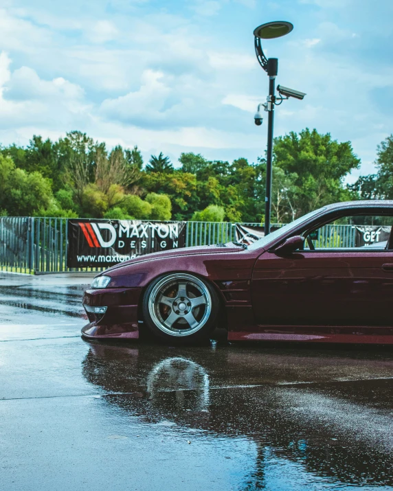 a red sports car parked on a wet surface