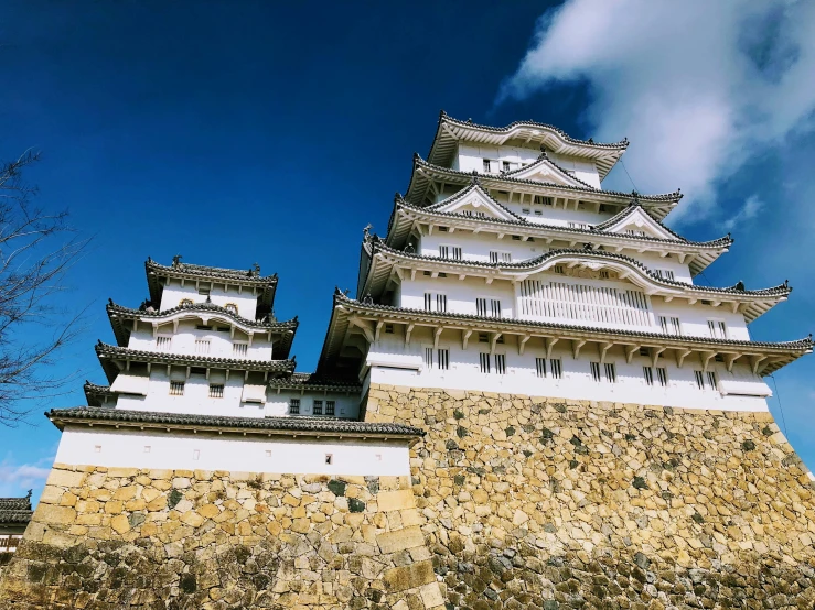 an ornately designed wall with two towers in front