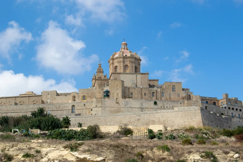 an old castle on a hill in the desert