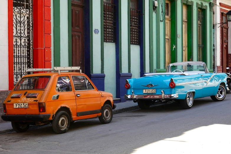 the cars are parked on the street by each other