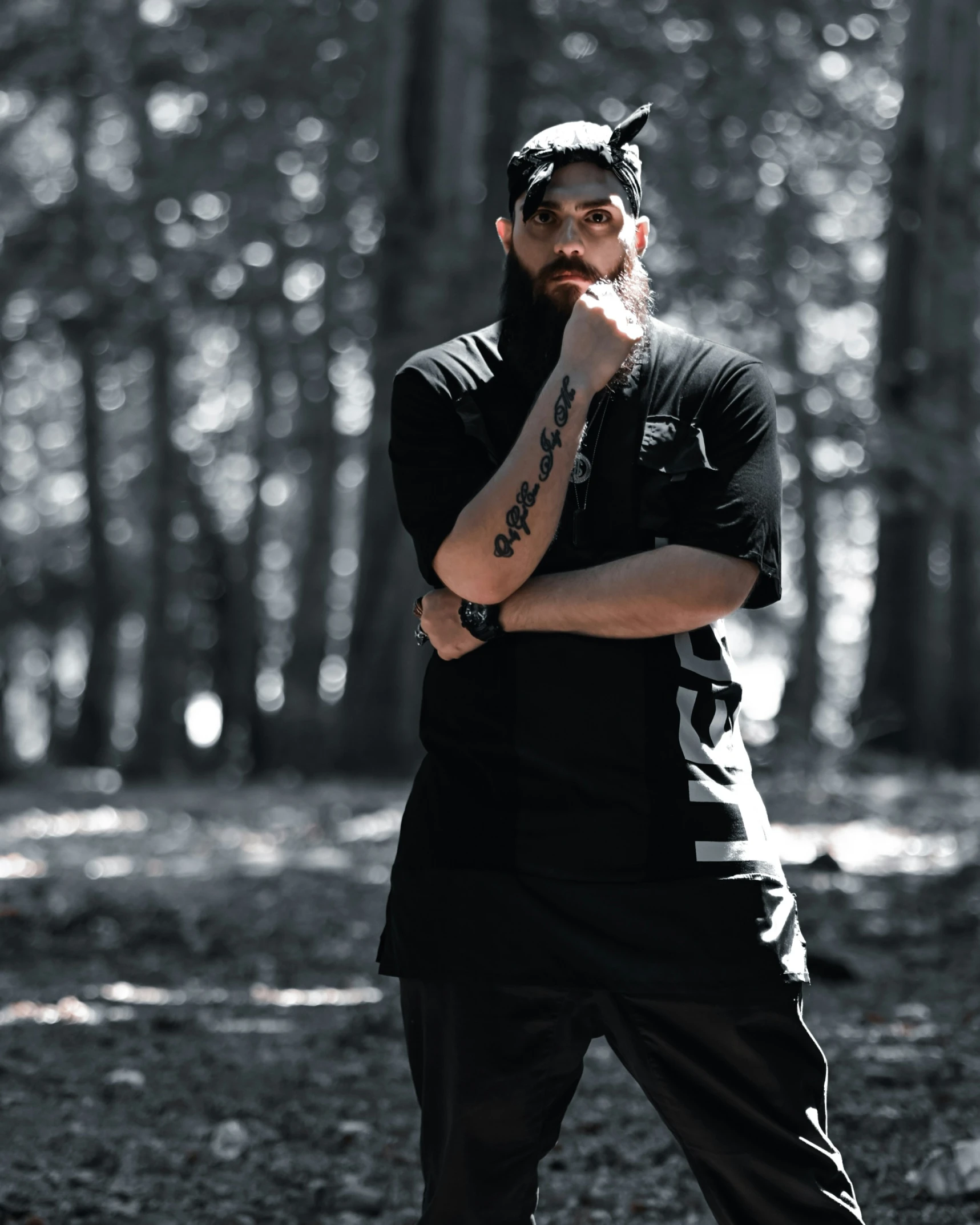 a bearded hipster in the forest, smoking a cigarette