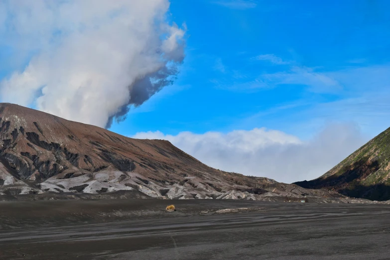 a big volcano with lots of smoke coming out of it