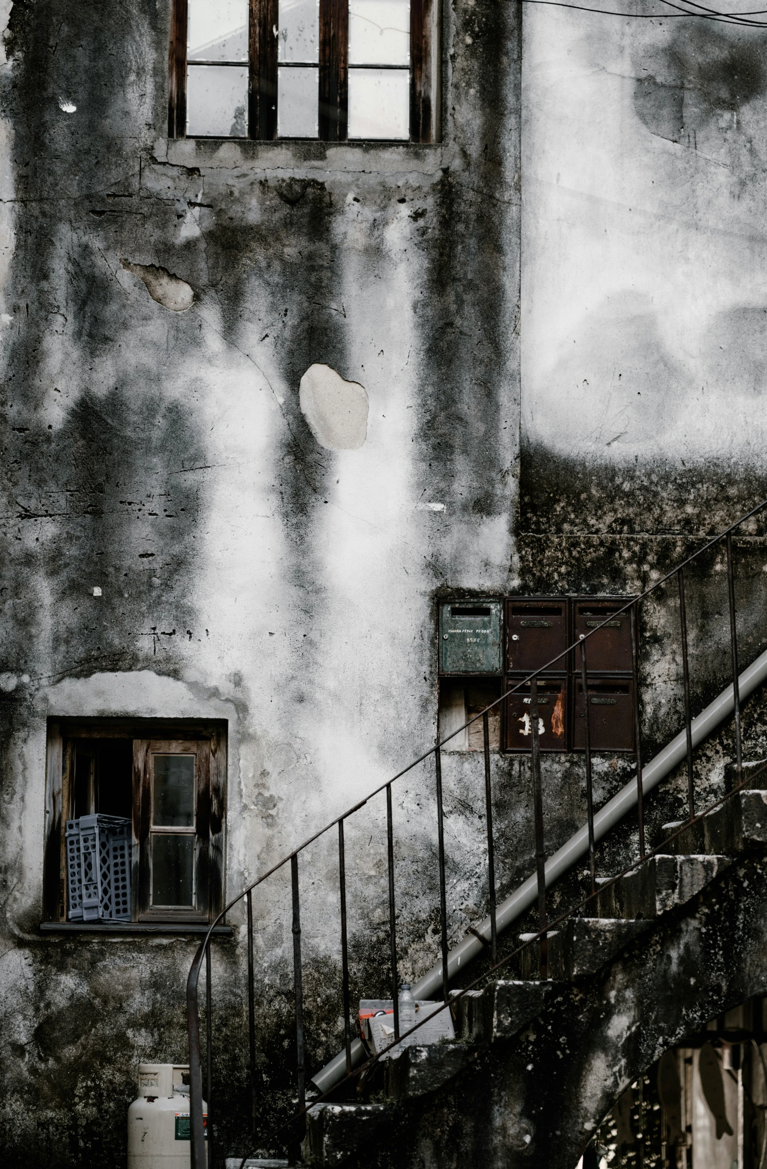 an uphill po of the staircase and windows of an old building