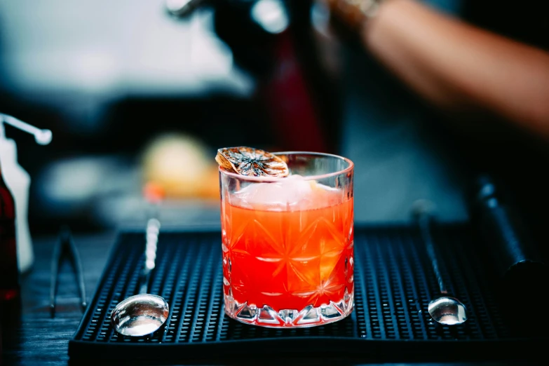 a close up of a glass with a drink on the table