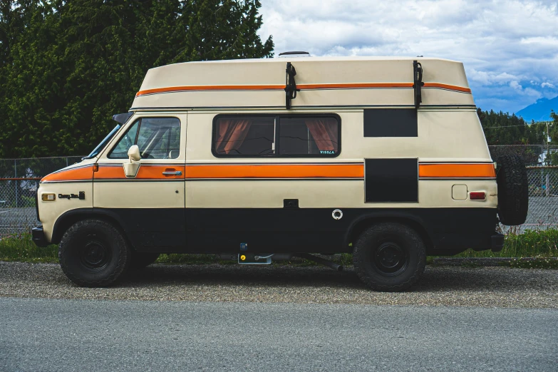 an old - fashioned camper van that is parked on the side of the road