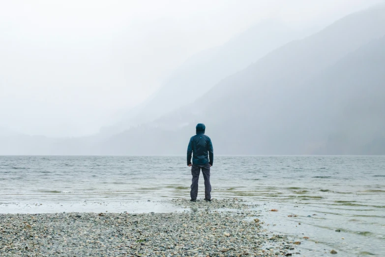 a person standing in the middle of a body of water