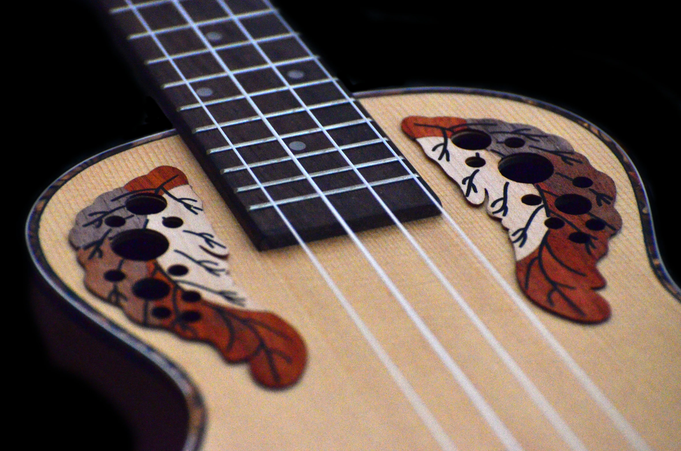 a ukulele has been decorated with colorful images