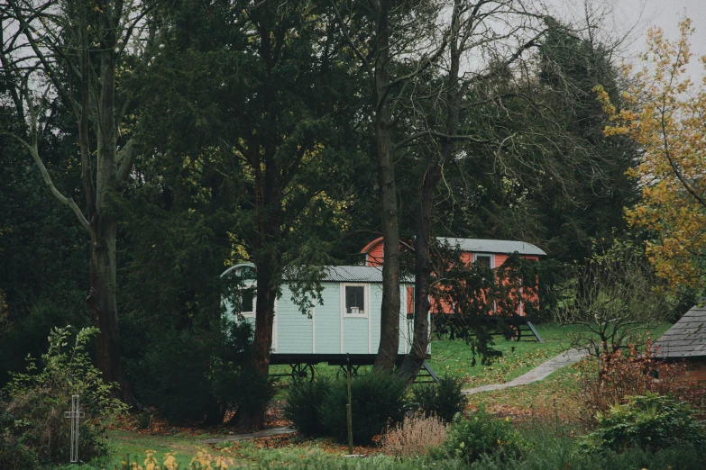 a small cottage in the woods near some trees