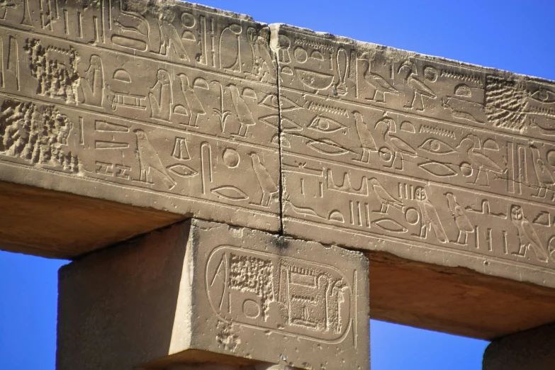 egyptian writing and symbols at the top of a structure