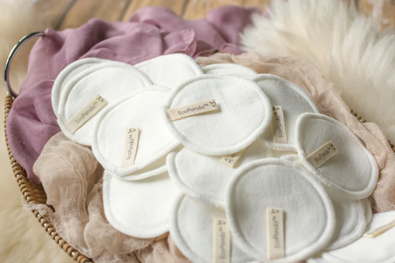 some white and pink round objects on top of some pink and beige sheets